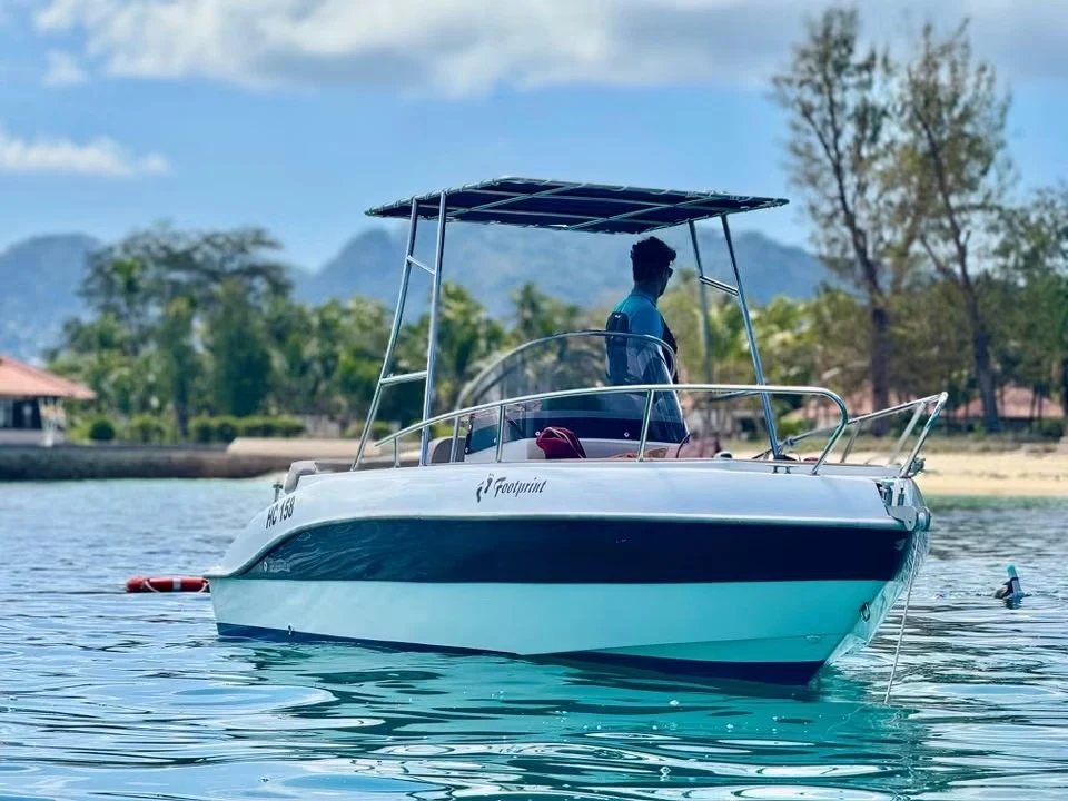 The actual Footprint Speedboat with its navy canopy in Seychelles waters